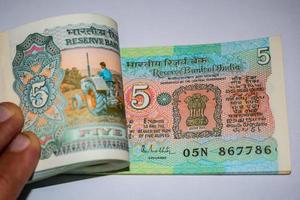 Old Five Rupee notes combined on the table, India money on the rotating table. Old Indian Currency notes on a rotating table, Indian Currency on the table photo
