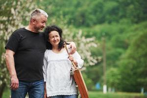 Lovely mature couple have a walk in the park at leisure time photo