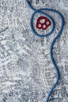 Abstract background. Isolated photo of climbing equipment. Part of carabiner lying on the white and grey colored table