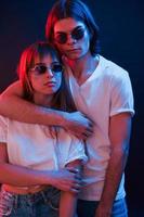 Closeness of people. Couple standing in dark room with red and blue neon lighting photo