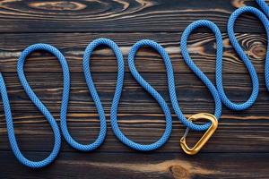 Horizontal view. Isolated photo of climbing equipment. Parts of carabiners lying on the wooden table