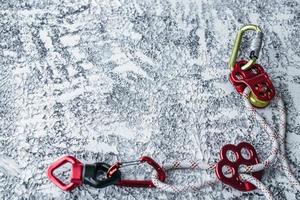 Metal material. Isolated photo of climbing equipment. Part of carabiner lying on the white and grey colored table