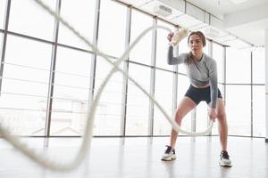 Front view. Sportive young woman have fitness day in the gym at morning time photo
