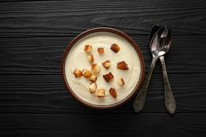 Creamy cauliflower soup with homemade croutons. photo