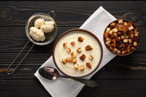 Creamy cauliflower soup with homemade croutons. photo