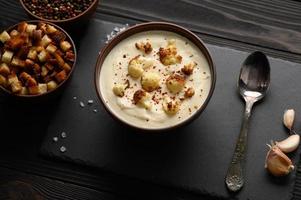 Creamy cauliflower soup with homemade croutons. photo