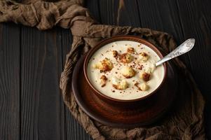 Creamy cauliflower soup with homemade croutons. photo