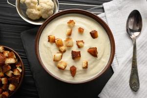 Creamy cauliflower soup with homemade croutons. photo