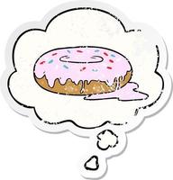 cartoon donut and thought bubble as a distressed worn sticker vector