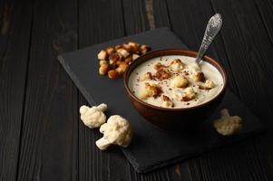 Creamy cauliflower soup with homemade croutons. photo