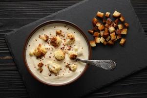 Creamy cauliflower soup with homemade croutons. photo