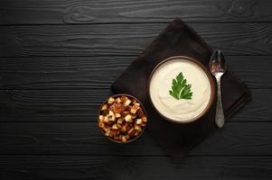 Creamy cauliflower soup with homemade croutons. photo