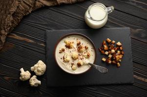 Creamy cauliflower soup with homemade croutons. photo