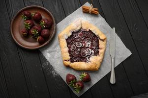 galette de fresa sobre fondo de madera oscura. hecho en casa foto