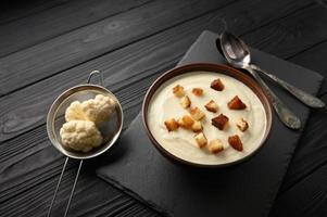 Creamy cauliflower soup with homemade croutons. photo