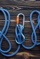 Conception of trust. Isolated photo of climbing equipment. Parts of carabiners lying on the wooden table