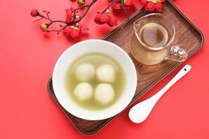 Ronde, Tang Yuan, glutinous rice dumpling balls, is a traditional warm drink made from ginger. The sticky rice balls in wedang ronde usually contain mashed beans and brown sugar. photo