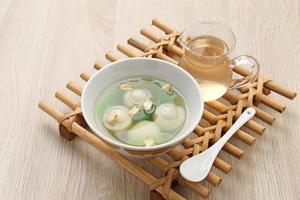 Ronde, Tang Yuan, glutinous rice dumpling balls, is a traditional warm drink made from ginger. The sticky rice balls in wedang ronde usually contain mashed beans and brown sugar. photo