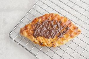 Caramelized Croissant Waffle or Croffle  with chocolate sauce photo