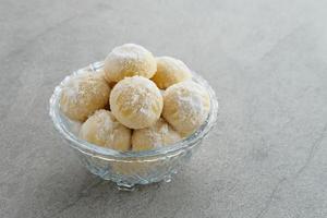 Kue Putri Salju or Snow White Cookies with crescent shaped. Made from flour, sugar and butter coated with powdered sugar. Popular to celebrate Eid al Fitr. photo