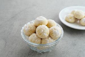 Kue Putri Salju or Snow White Cookies with crescent shaped. Made from flour, sugar and butter coated with powdered sugar. Popular to celebrate Eid al Fitr. photo