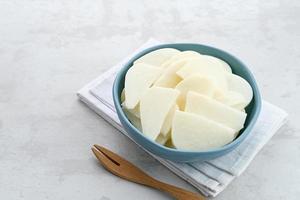 A bowl of fresh jicama or bengkoang, jicama slices, gut health. photo