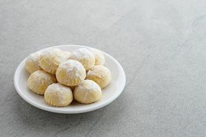 Kue Putri Salju or Snow White Cookies with crescent shaped. Made from flour, sugar and butter coated with powdered sugar. Popular to celebrate Eid al Fitr. photo