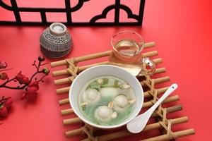 Ronde, Tang Yuan, glutinous rice dumpling balls, is a traditional warm drink made from ginger. The sticky rice balls in wedang ronde usually contain mashed beans and brown sugar. photo