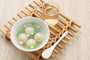 Ronde, Tang Yuan, glutinous rice dumpling balls, is a traditional warm drink made from ginger. The sticky rice balls in wedang ronde usually contain mashed beans and brown sugar. photo