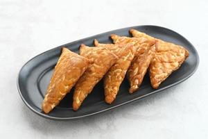 Tempeh, Tempe Goreng or Fried tempeh is Indonesia traditional food, made from fermented soybean seeds wrapped in banana leaves. Salty and savory, served as a side dish or snack photo