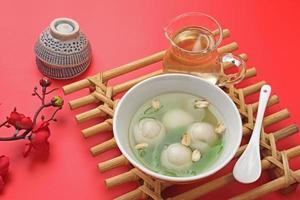 Ronde, Tang Yuan, glutinous rice dumpling balls, is a traditional warm drink made from ginger. The sticky rice balls in wedang ronde usually contain mashed beans and brown sugar. photo