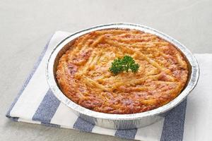 Baked Macaroni Schotel in an aluminium foil cup. Selective focus. photo