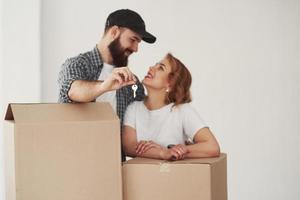 Cheerful mood. Happy couple together in their new house. Conception of moving photo