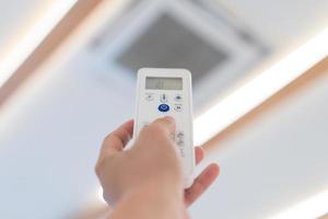 Focus on Power button of Air Conditioner Remote control, to open and turn off it at ceilling of seminar hall. photo