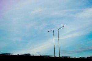 Clearly beautiful blue sky with expressway tuck and lamp post. photo