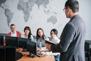 How is your deals. Group of people at business conference in modern classroom at daytime photo