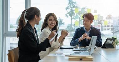 joven grupo empresarial asiático con el trabajo creativo, charla e intercambio de ideas compartidas en la reunión foto