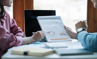 Business People Meeting to analyse and discuss and brainstorming the financial report chart data in office Financial advisor teamwork and accounting concept photo