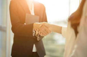 Close up of Business people shaking hands, finishing up meeting, business etiquette, congratulation, merger and acquisition concept photo