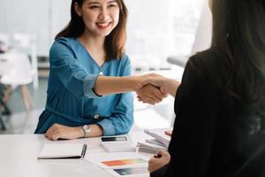 Close up of Business people shaking hands, finishing up meeting, business etiquette, congratulation, merger and acquisition concept photo