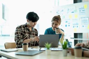 group of young creative asian work cooperate with diverse team at office briefing, focused biracial businessman head meeting, collaborate discuss business ideas with colleagues at meeting photo