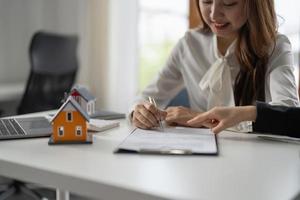 experienced real estate agent showing house model to client and ready to sign contract photo