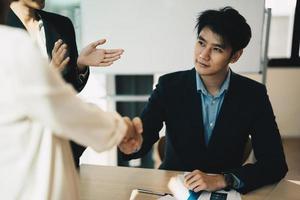 Partnership. asian business people shaking hand after business job interview in meeting room at office, congratulation, investor, success, interview, partnership, teamwork, financial photo