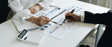 Close up business team hands at working with financial plan, meeting, discussion, brainstorming on the office desk photo