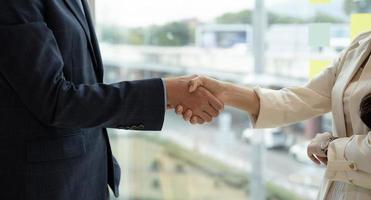 Business asian agreement and successful negotiation concept, businessman in suit shake hand with customer, client after formal communication and contract deal success photo