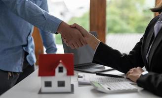 Real estate agents and customers shake hands to congratulate on signing a contract to buy a house with land and insurance, handshake and Good response concept photo