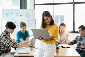 Group of asian young creative happy enjoy laugh smile and great success emotion teamwork people business startup entrepreneur casual brainstorm business meeting office background photo