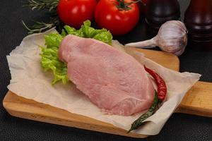 Raw Turkey steak served rosemary photo