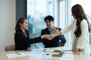 Business asian people shaking hands, finishing up meeting, business etiquette, congratulation, merger and acquisition concept photo