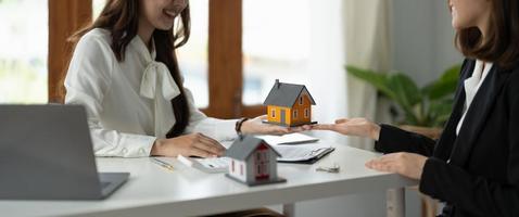 experienced real estate agent showing house model to client and ready to sign contract photo